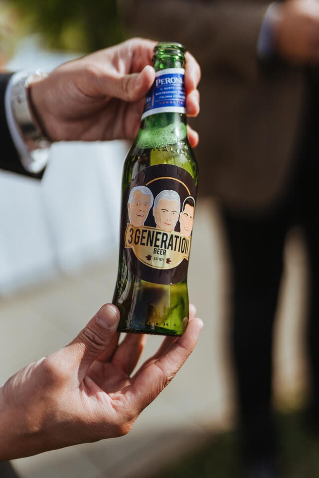A man helps Toyota mark 50 years in business with a branded beer bottle.