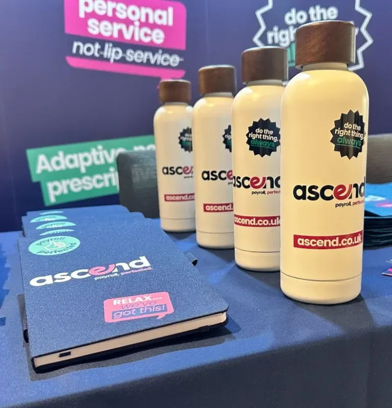 Ascend Payroll branded notebooks and water bottles designed by Sourcefour for a conference event table
